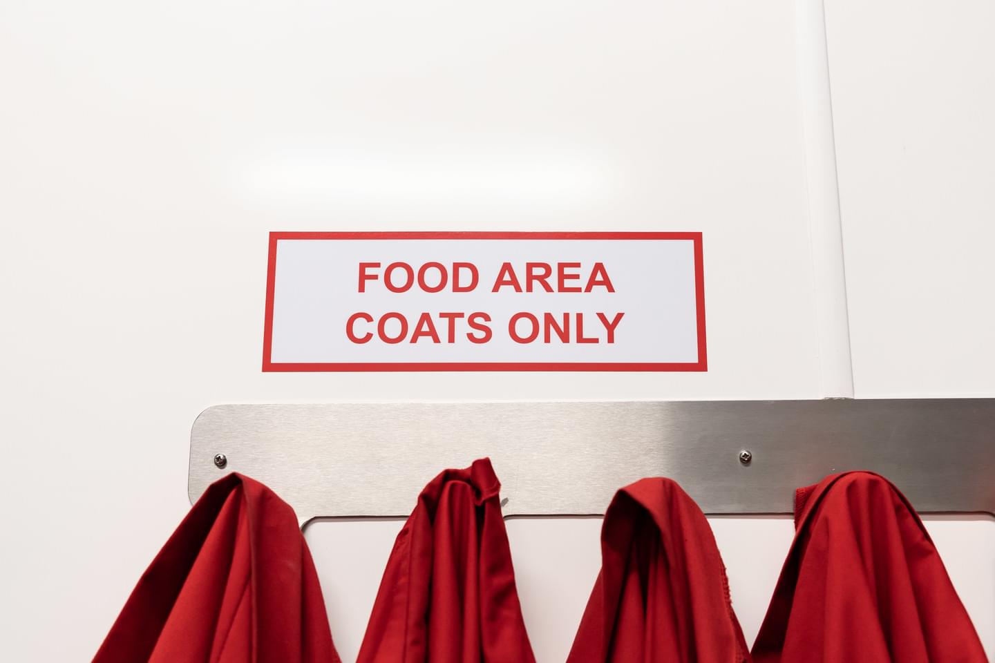 A sign saying 'Food area coats only'